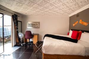 a bedroom with a bed with a coffered ceiling at Nolapeace B&B in East London
