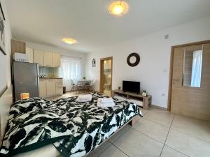 a large bedroom with a bed and a kitchen at Apartments Easy in Dramalj