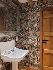 a bathroom with a sink and a wall at The Manor Pen in Lenham
