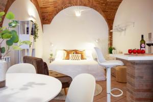 a bedroom with a bed and a table and chairs at Medieval flat with whirlpool bath in Perugia