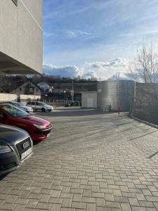a parking lot with cars parked next to a building at Crystal in Suceava