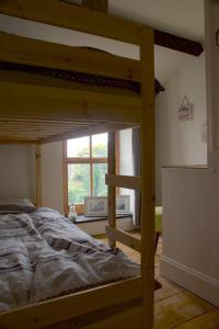 a bedroom with a bunk bed and a window at Cwmwl Gwyn Cottage in the heart of the old town in Llantrisant