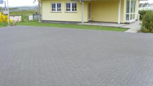 a brick driveway in front of a house at Mawo Lodge in Lohfelden