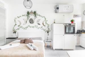 Habitación blanca con cama y nevera. en [Eden House SanSiro-Duomo] Netflix & Design, en Milán