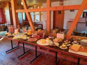 a table with food on it in a room at Sonnenberg Hostel and Dormitories in Mürren