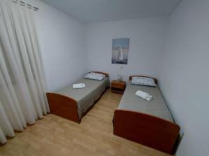 Postel nebo postele na pokoji v ubytování Rumora Ivan Apartment