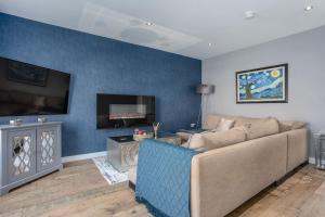 a living room with a couch and a tv at The Nest - 15 min walk to Craigavon Area Hospital in Craigavon