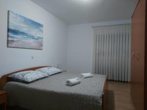 Postel nebo postele na pokoji v ubytování Rumora Ivan Apartment