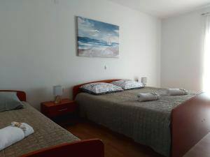 Postel nebo postele na pokoji v ubytování Rumora Ivan Apartment