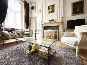 a living room with a glass table and a fireplace at Caporizon-Sarlat l'élégance-T2 Plein centre cité médiévale in Sarlat-la-Canéda