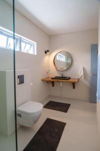 a bathroom with a toilet and a mirror at Waterside Apartments in Willemstad