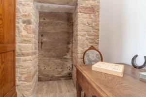 a room with a wooden wall with a wooden desk at Le Grand Pressoir - Grande maison avec jardin in Nanton