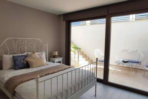 a bedroom with a bed and a sliding glass door at Bodrum merkez'de Havuzlu, Saunalı, müstakil villa in Bodrum City