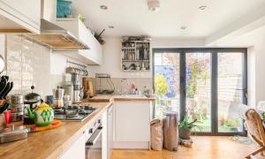 a kitchen with white counters and a stove top oven at Three Bedroomed Victorian Family House, Garden in Brighton & Hove