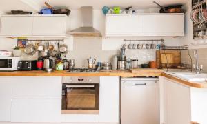 a kitchen with white cabinets and white appliances at Three Bedroomed Victorian Family House, Garden in Brighton & Hove