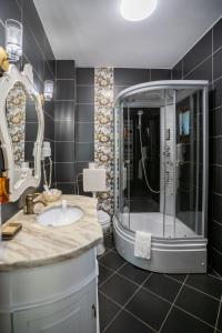 a bathroom with a large shower and a sink at Opus View in Sinaia