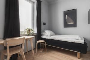 Postel nebo postele na pokoji v ubytování Heimen Hotel