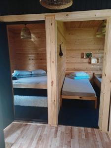 a room with two beds in a cabin at Chill Up in Vecpiebalga