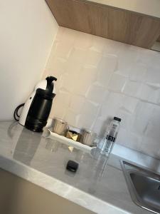 a kitchen counter with a coffee pot and a sink at Garsoniera Luca in Drobeta-Turnu Severin