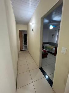 a hallway leading to a room with a bed at Casa Férias Paraty - yeshua in Paraty