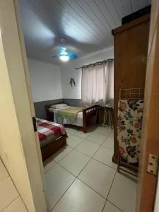 a small room with two beds and a room with at Casa Férias Paraty - yeshua in Paraty