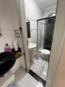 a bathroom with a toilet and a sink and a shower at Casa Férias Paraty - yeshua in Paraty