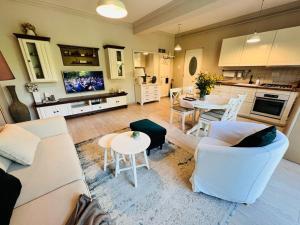 a living room with a couch and a table at MVS Apartment in Giroc