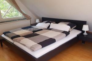 a large bed in a room with a window at Dachwohnung mit Wasserblick und eigenem Bootssteg in Berlin