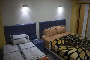 a bedroom with two beds at Ullanka Apart Hotel in Encarnación