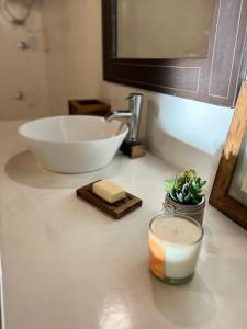 a bathroom counter with a sink and a candle on it at Estancia San Mateo in San Miguel del Monte +34 photos