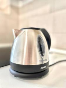a silver and black toaster sitting on a counter at Skyscraper 11 in Cinisello Balsamo
