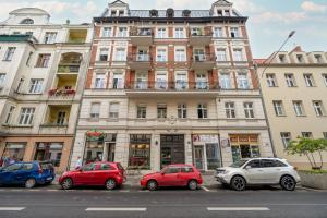 a group of cars parked in front of a building at Bright & Comfortable Apartment Garbary 35 Poznań Old Town by Renters in Poznań