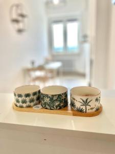 three bowls sitting on a wooden tray on a counter at Skyscraper 11 in Cinisello Balsamo