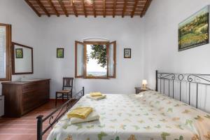 a bedroom with a bed and a desk and a window at Martignana in Empoli
