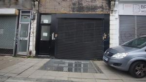 a car parked in front of a garage at One Bedroom Apartment at Islington in London