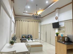 a living room with a couch and a table at House near Suvarnabhumi Airport in Ban Hua Takhe