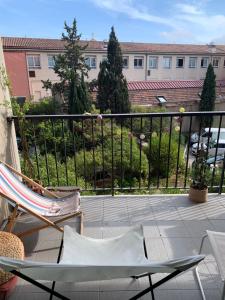d'une terrasse avec deux chaises et d'un balcon avec un bâtiment. dans l'établissement Lokitas, à Marseille