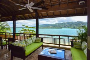 a living room with a view of the water at Afimi Beach House Montego Bay 4BR Beachfront Villa in Montego Bay