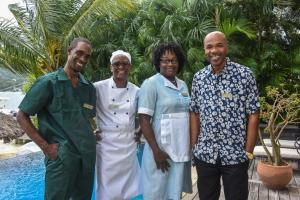a group of people posing for a picture by a pool at Afimi Beach House Montego Bay 4BR Beachfront Villa in Montego Bay +28 photos