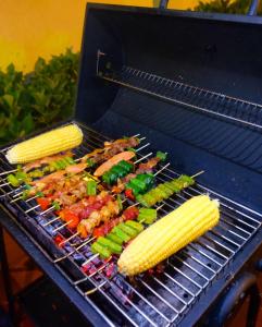a grill with corn and vegetables on it at Là Lá La Home in Da Lat