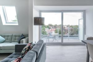 a living room with a couch and a large window at Newly Refurbished 2 bed with Fantastic View in London