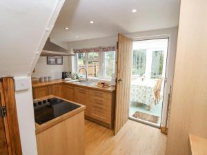 a kitchen with a sink and a counter top at Newbury Cottage in Bourton on the Water