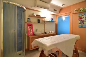 a bathroom with a table and a sink and a shower at Oriente Suites e Spa in Ischia