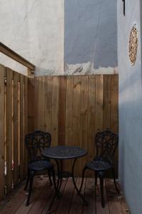 two chairs and a table on a wooden deck at B&B Midtown Amsterdam suites in Amsterdam