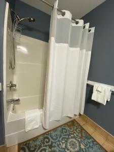 a bathroom with a tub and a shower with white towels at Allegheny Spg - Cozy Condo Ski from our patio in Dunmore