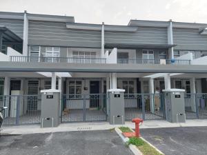 a building with two machines in a parking lot at Anis Homestay Nilai in Nilai