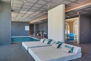 a living room with a couch and a swimming pool at Odalys City Marseille Centre Euromed in Marseille