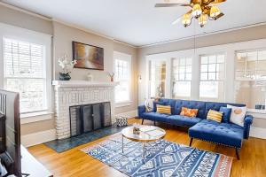 a living room with a blue couch and a fireplace at Sydney Spring Garden in Jacksonville