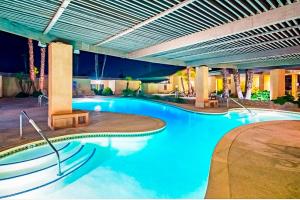 a large swimming pool with blue water in a building at Sky Valley Serenity in Rimlon