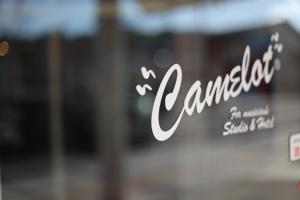 a glass door with the word cambridge on it at Hotel Camelot in Fujikawaguchiko